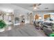 Open living room features a smooth transition to dining and kitchen areas with tile and plush carpeting at 11502 E Rafael Ave, Mesa, AZ 85212