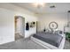 Bright main bedroom with a ceiling fan, carpet, and a door to the bathroom at 11502 E Rafael Ave, Mesa, AZ 85212