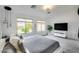 Bright main bedroom featuring dual windows, a television, and a ceiling fan at 11502 E Rafael Ave, Mesa, AZ 85212