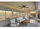 Relaxing outdoor patio with comfortable seating, ceiling fan, and views of the pool and backyard at 11502 E Rafael Ave, Mesa, AZ 85212