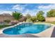 Backyard pool featuring a charming rock waterfall, creating a tranquil outdoor oasis at 11502 E Rafael Ave, Mesa, AZ 85212