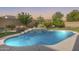 Backyard pool area featuring a waterfall feature and manicured landscaping at 11502 E Rafael Ave, Mesa, AZ 85212