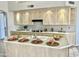 Bright kitchen featuring an island, light wood cabinets, and modern appliances at 11645 E Bella Vista Dr, Scottsdale, AZ 85259