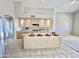 Open kitchen featuring an island, light wood cabinets, and modern appliances at 11645 E Bella Vista Dr, Scottsdale, AZ 85259