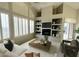 Stylish living room with a vaulted ceiling, a fireplace, built-in shelving, and ample natural light at 11645 E Bella Vista Dr, Scottsdale, AZ 85259