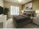Comfortable bedroom featuring a cushioned headboard, neutral decor, and a ceiling fan at 11645 E Bella Vista Dr, Scottsdale, AZ 85259