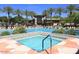 Beautiful community pool area with a spa, surrounded by palm trees and lounge chairs at 11645 E Bella Vista Dr, Scottsdale, AZ 85259