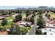 Expansive aerial view of residential homes next to a golf course, offering scenic community living with mountain views at 11837 N 40Th Pl, Phoenix, AZ 85028
