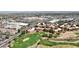 Aerial view showing a golf course community with shopping, roads, and housing, set against a mountainous backdrop at 11837 N 40Th Pl, Phoenix, AZ 85028