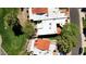 Bird's-eye view of neighborhood homes with terra-cotta roofs, showcasing well-maintained lawns and mature trees, on a golf course at 11837 N 40Th Pl, Phoenix, AZ 85028