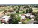 An aerial view reveals residences with terracotta roofs alongside a golf course and tree-lined streets at 11837 N 40Th Pl, Phoenix, AZ 85028