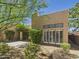 Back exterior view with desert landscaping, stucco walls, covered patio, and shuttered windows at 11837 N 40Th Pl, Phoenix, AZ 85028