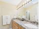 Bathroom featuring double sinks, granite countertops, and a bright, well-lit vanity at 11837 N 40Th Pl, Phoenix, AZ 85028
