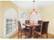 Bright breakfast nook with large windows and a round table with four chairs at 11837 N 40Th Pl, Phoenix, AZ 85028