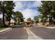 A gated community entrance features mature trees and landscaping on a quiet street at 11837 N 40Th Pl, Phoenix, AZ 85028