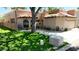 Charming home featuring a red tile roof, arched windows, and a well-manicured lawn, nestled under a mature shade tree at 11837 N 40Th Pl, Phoenix, AZ 85028