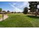 A lush green golf course, framed by mature trees and blue skies, provides a scenic backdrop at 11837 N 40Th Pl, Phoenix, AZ 85028