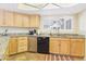 Kitchen with granite countertops, stainless steel dishwasher, and wood cabinets at 11837 N 40Th Pl, Phoenix, AZ 85028