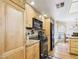 Kitchen featuring granite countertops, black appliances, and wood cabinets at 11837 N 40Th Pl, Phoenix, AZ 85028