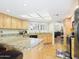 Bright kitchen with granite countertops, wood cabinets, and large island with bar seating at 11837 N 40Th Pl, Phoenix, AZ 85028