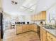 Kitchen featuring granite countertops, an island, wood cabinets, and a bright skylight at 11837 N 40Th Pl, Phoenix, AZ 85028