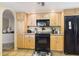 Kitchen with black appliances, wood cabinets, and granite countertops at 11837 N 40Th Pl, Phoenix, AZ 85028