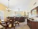 Inviting open-concept living area featuring a dining set, comfortable seating, a fireplace, and bright natural light at 11837 N 40Th Pl, Phoenix, AZ 85028