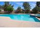 Community pool surrounded by lush greenery, providing a tranquil retreat for residents at 11837 N 40Th Pl, Phoenix, AZ 85028