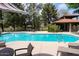 Community pool with lounge chairs, tables, and shade, creating a relaxing atmosphere at 11837 N 40Th Pl, Phoenix, AZ 85028