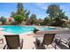 Sparkling pool and spa area with lounge chairs, umbrellas and lush landscaping at 11837 N 40Th Pl, Phoenix, AZ 85028