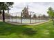 Fenced tennis court surrounded by lush landscaping in a well-maintained community at 11837 N 40Th Pl, Phoenix, AZ 85028