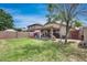 This is an expansive backyard featuring a covered patio and well-maintained landscaping at 12048 W Dahlia Dr, El Mirage, AZ 85335