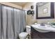 Bathroom featuring modern vanity with sink, stylish mirror, and shower with gray curtain at 12048 W Dahlia Dr, El Mirage, AZ 85335