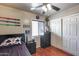This charming bedroom features a ceiling fan, wood-look flooring, and a closet with sliding doors at 12048 W Dahlia Dr, El Mirage, AZ 85335