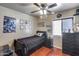 Bedroom featuring dark furnishings, ceiling fan, light walls, and Star Wars themed decorations at 12048 W Dahlia Dr, El Mirage, AZ 85335