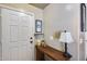 Welcoming entryway features neutral walls, a wooden console table, and stylish decor, creating a warm first impression at 12048 W Dahlia Dr, El Mirage, AZ 85335