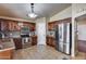 Bright kitchen boasts stainless steel appliances, ample dark wood cabinetry, and tile flooring for a modern touch at 12048 W Dahlia Dr, El Mirage, AZ 85335