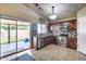 Well-lit kitchen features stainless steel appliances, dark wood cabinets, and a convenient sliding door to the backyard at 12048 W Dahlia Dr, El Mirage, AZ 85335