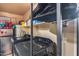 This functional laundry room has a washer, dryer, shelving, and mini refrigerator at 12048 W Dahlia Dr, El Mirage, AZ 85335