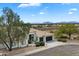 Attractive single-story home in a desert community with lush landscaping and a large front yard at 12055 E Clinton St, Scottsdale, AZ 85259