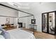 Well-lit bedroom with four-poster bed, fireplace, and outside access at 12055 E Clinton St, Scottsdale, AZ 85259