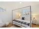 Bright bedroom showcasing a four-poster bed, stylish decor, and ample natural light at 12055 E Clinton St, Scottsdale, AZ 85259