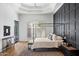 Spacious bedroom featuring modern black accent wall, four-poster bed, and stylish decor at 12055 E Clinton St, Scottsdale, AZ 85259