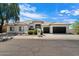 Well-maintained single-story home with a tile roof, manicured landscaping, and a three-car garage at 12055 E Clinton St, Scottsdale, AZ 85259