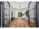 Grand foyer featuring high ceilings, a modern chandelier, and double glass entry doors at 12055 E Clinton St, Scottsdale, AZ 85259