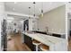 Bright, modern kitchen with an island, marble countertops, pendant lights, and stainless steel appliances at 12055 E Clinton St, Scottsdale, AZ 85259