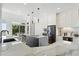 Contemporary kitchen with marble countertops, a kitchen island with seating, and modern appliances at 12055 E Clinton St, Scottsdale, AZ 85259