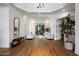 Elegant living room with hardwood floors, a tray ceiling, and bright natural light at 12055 E Clinton St, Scottsdale, AZ 85259