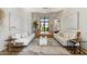 Open-concept living room with light wood floors, neutral decor, and a large entryway at 12055 E Clinton St, Scottsdale, AZ 85259
