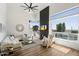 Bright living room with high ceilings, a modern fireplace, large windows, and comfortable seating at 12055 E Clinton St, Scottsdale, AZ 85259